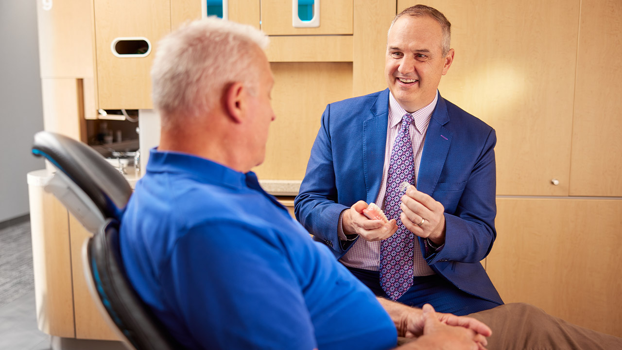 Dr. Andrew J. Dvonch with a patient discussing cosmetic dentistry